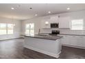 Modern kitchen with white cabinets, granite countertops and island at 100 Lemon Drop Ln, Franklinton, NC 27525