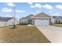 Two-story house with gray siding, white garage door, and landscaped yard at 8588 Kenridge Ln, Fuquay Varina, NC 27526