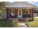 Brick house with covered porch and landscaping at 104 N Jackson St, Dunn, NC 28334