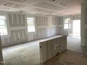 Spacious living area with walls and windows under construction at 2217 Tulip Bloom Ln, Morrisville, NC 27560