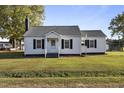 Simple white one-story house, featuring a classic design at 2494 Joel Johnson Rd, Lillington, NC 27546