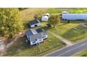 Aerial view showcasing a house and multiple outbuildings on a spacious property at 2494 Joel Johnson Rd, Lillington, NC 27546