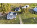 Aerial view of a house with detached workshop and barn on a large lot at 2494 Joel Johnson Rd, Lillington, NC 27546