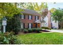 Brick home with a gray garage, shutters, and landscaping at 2257 Brisbayne Cir, Raleigh, NC 27615