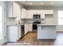 Modern kitchen with white cabinets and granite counters at 195 Sawyer Mill Dr, Dunn, NC 28334