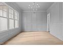 Bright dining room features hardwood floors, wainscoting, and a large window at 2105 Gentry Rd, Wake Forest, NC 27587