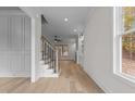 View of hardwood floors, staircase, and large window from entryway at 2105 Gentry Rd, Wake Forest, NC 27587