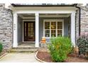 Front porch with stone accents, double doors, and a charming pumpkin display at 204 Harvest Ln, Pittsboro, NC 27312