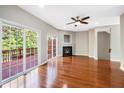 Living room with hardwood floors, fireplace, and sliding glass doors to deck at 254 Linden Park Ln Ln, Cary, NC 27519