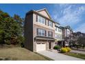 Three-story townhome with a brick and shingle exterior and a two-car garage at 254 Linden Park Ln Ln, Cary, NC 27519