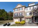 Three-story townhome with brick and shingle exterior, two-car garage, and landscaping at 254 Linden Park Ln Ln, Cary, NC 27519