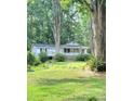 White ranch home with a covered porch, set back from the road and surrounded by trees at 325 Ranch Farm Rd # A - B, Raleigh, NC 27603
