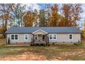 Beige ranch home with a gray roof and porch at 5724 Walters Ln, Burlington, NC 27217