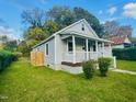 Charming bungalow with a front porch, steps, and well-manicured lawn at 250 Horner St, Henderson, NC 27536