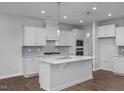 Modern kitchen featuring white cabinets, quartz countertops, and an island at 115 Fairwinds Dr, Lillington, NC 27546