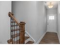 Wooden staircase with black metal balusters leading to the second floor at 115 Fairwinds Dr, Lillington, NC 27546