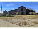 Rustic barn with covered area and silo at 379 John Deere Ln, Bear Creek, NC 27207