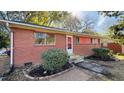 Front view of a red brick ranch house with landscaping at 720 Darby St, Raleigh, NC 27610