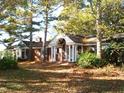 Brick ranch house with covered porch and mature trees at 6349 Elevation Rd, Benson, NC 27504