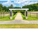 Entrance to a park with a walkway and park sign at 207 Augusta Pond Way # 154, Raleigh, NC 27603