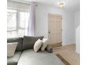 Living room with gray sectional sofa, built in shelving and entryway at 1812 Orange Grove Rd # 101, Hillsborough, NC 27278