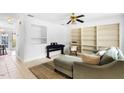 L-shaped living room with built-in shelving, rocking chair and ceiling fan at 1812 Orange Grove Rd # 101, Hillsborough, NC 27278