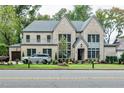 Brick two-story home with a gray roof and landscaping at 216 Dartmouth Rd, Raleigh, NC 27609