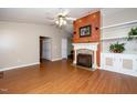 Spacious living room featuring hardwood floors, fireplace, and built-in shelving at 928 Magnolia Ridge Way, Fuquay Varina, NC 27526