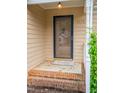 Brick steps leading to the front door with a glass storm door and welcome mat at 6220 Sweden Dr, Raleigh, NC 27612