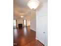 Spacious living room with hardwood floors, a fireplace and lots of natural light at 6220 Sweden Dr, Raleigh, NC 27612