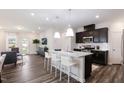 Modern kitchen with granite countertops and dark cabinets at 518 Hester Rd, Durham, NC 27703