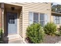 Gray front door with glass panes and welcome mat at 14 Stone Village Ct, Durham, NC 27704