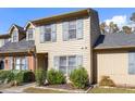Tan two-story townhome with gray shutters and landscaping at 14 Stone Village Ct, Durham, NC 27704