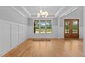 Bright dining room with hardwood floors, large windows, and coffered ceiling at 5100 Grist Stone Way, Youngsville, NC 27596