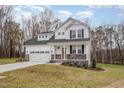 Two-story house with white siding, stone accents, and a two-car garage at 67 Earl Ct, Smithfield, NC 27577