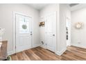 Bright entryway with hardwood floors and coat closet at 181 Glenwood Pl, Kenly, NC 27542