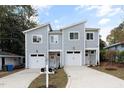 Modern gray duplex with two-car garages and front yard at 451 Longfellow St, Fuquay Varina, NC 27526