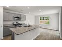 Modern kitchen with gray cabinets, granite countertops, and stainless steel appliances at 236 Holton St, Smithfield, NC 27577