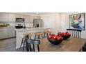 Open kitchen with granite island, stainless steel appliances, and dining area at 241 Holton St, Smithfield, NC 27577