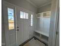 Open entryway with a white door and built-in storage at 95 Mapledale Ct, Benson, NC 27504