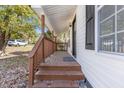 Inviting front porch with wooden steps and railing at 3901 Virginia St, Raleigh, NC 27610