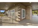 Spacious deck with stone fireplace and log cabin details at 1829 Old Batten Rd, Selma, NC 27576