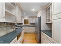 Bright kitchen with light cabinets, granite countertops, and hardwood floors at 1604 Green Pine Ct, Raleigh, NC 27614