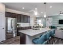 Open kitchen island with seating and stainless steel appliances at 2896 Huxley Way, Apex, NC 27502