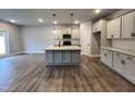 Modern kitchen with gray cabinets, center island and stainless steel appliances at 132 S Mistflower St, Clayton, NC 27520