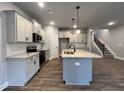 Modern kitchen with island, stainless steel appliances and gray cabinets at 132 S Mistflower St, Clayton, NC 27520