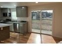 Modern kitchen with stainless steel appliances and sliding glass door at 876 Vanco Mill Rd, Henderson, NC 27537