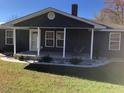 Newly renovated home with a dark blue exterior and front porch at 876 Vanco Mill Rd, Henderson, NC 27537