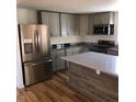 Modern kitchen with stainless steel appliances and island at 876 Vanco Mill Rd, Henderson, NC 27537