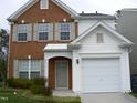 Two-story brick and vinyl home with a two-car garage and landscaped lawn at 142 Brentfield Loop, Morrisville, NC 27560